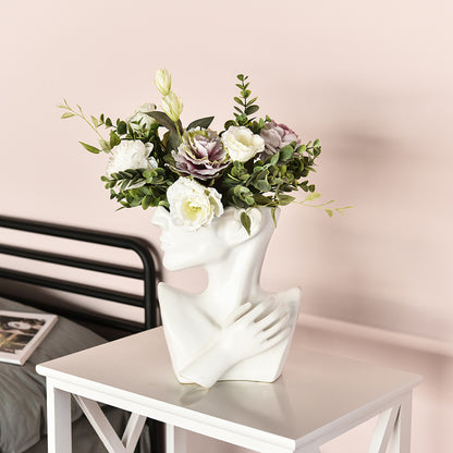 Artistic flower vase displayed on a living room shelf